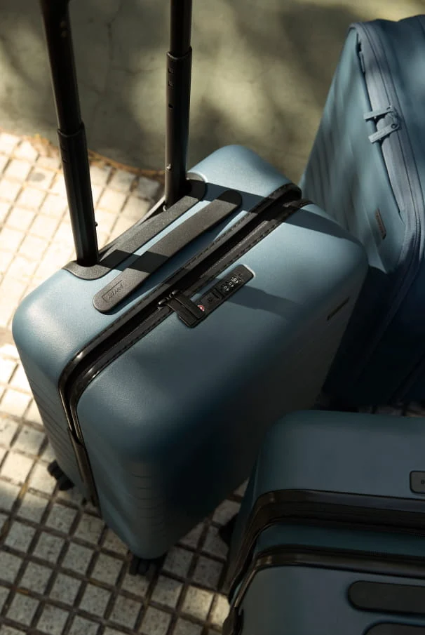 Three blue suitcases on a textured surface