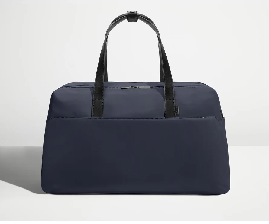 Front view of Away's Weekender duffle in Navy Blue with handles up